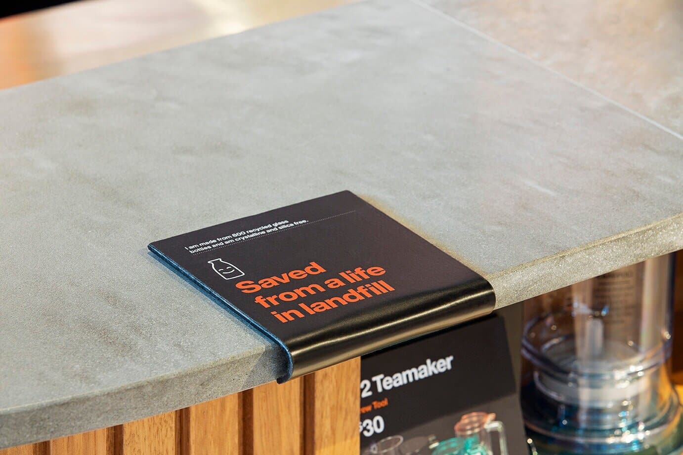 Eco Benchtops' sustainable benchtops featured at T2 Bondi Junction, accompanied by signage highlighting materials saved from landfill.